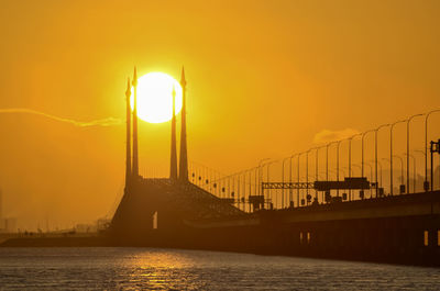 View of bridge over sea during sunset