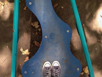 Low section of person standing on metal floor