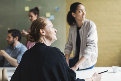 Businesswomen listening to presentation in conference room