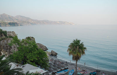 High angle view of sea and mountains against clear sky