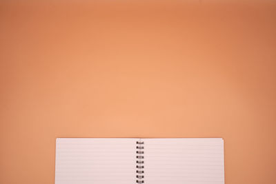 Close-up of open book against orange background
