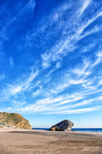 Scenic view of beach against blue sky