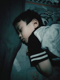 High angle view of boy standing against wall