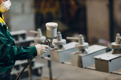 Midsection of man working in workshop