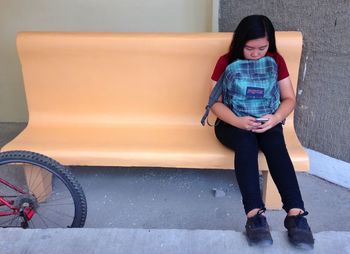 Full length of teenage girl using mobile phone