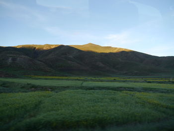 Countryside landscape against mountain range