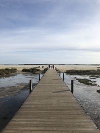 Pier over sea against sky