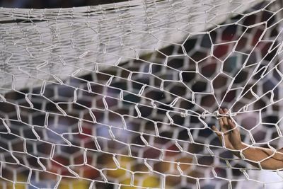 Cropped hand of person holding net