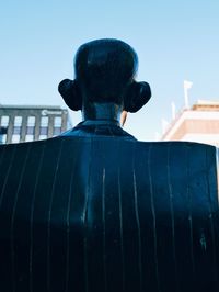 Low angle view of statue against clear blue sky