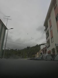 View of city against cloudy sky