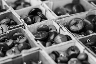 Close-up of buttons in containers