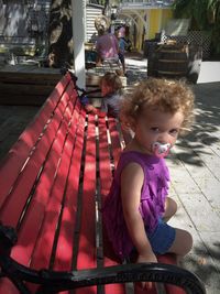 Portrait of cute girl sitting outdoors