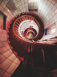 Low section of woman standing on spiral staircase