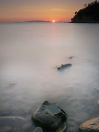 Scenic view of sea against sky at sunset