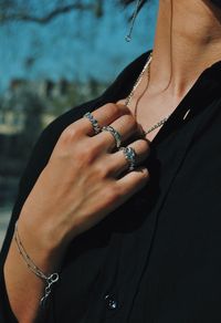 Close-up of woman hand with tattoo against blurred background