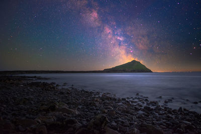 Scenic view of sea against sky at night