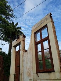 Low angle view of building against cloudy sky