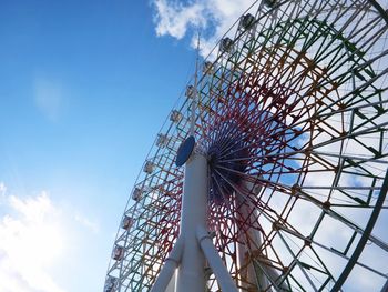 Low angle view of ferris wheel against sky