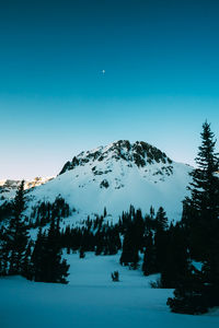 Scenic view of snowcapped mountains against clear sky