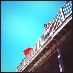 Low angle view of built structure against clear blue sky