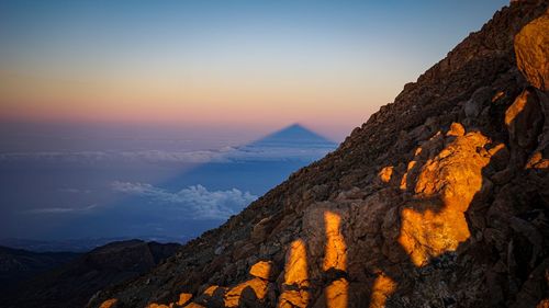 Scenic view of mountains against sky during sunrise