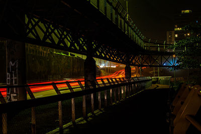Bridge over river in city at night