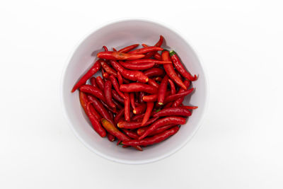 High angle view of red chili pepper over white background