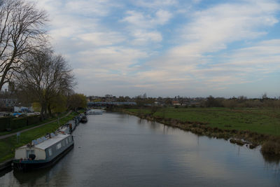 Scenic view of river against sky in city