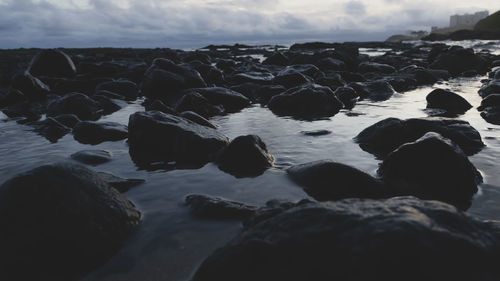 Rocks in sea against sky