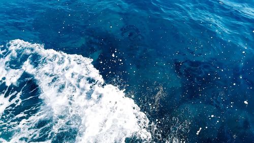 High angle view of waves splashing on sea