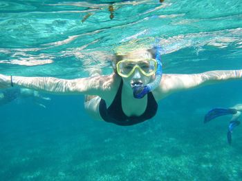 Portrait of young woman snorkeling in sea