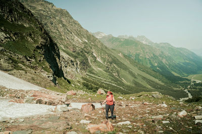 Rear view of man climbing on mountain