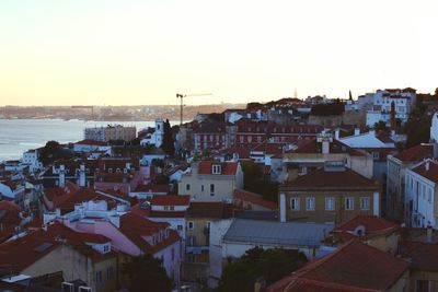 Residential district by sea against sky