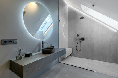 Beautiful elegant modern luxury bathroom interior in luxury home and glass door shower, mirror