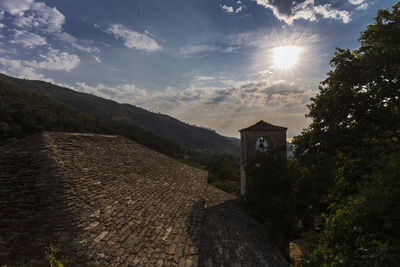 Old ruin amidst buildings against sky