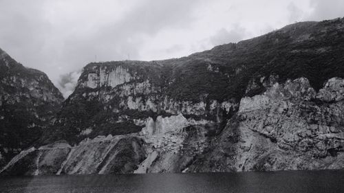 Scenic view of mountains against cloudy sky