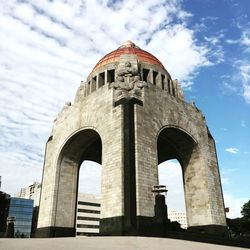 Low angle view of historical building against cloudy sky