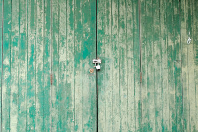 Close-up of padlocks on metal door