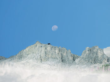 Scenic view of snowcapped mountains against clear blue sky