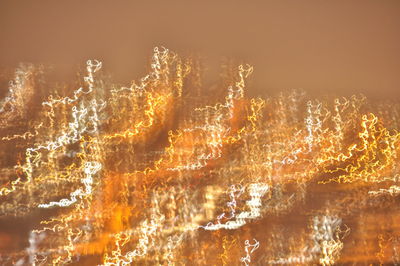 Full frame shot of illuminated lights against sky at night