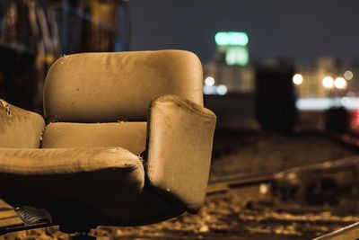 Close up of abandoned chair outdoors at night