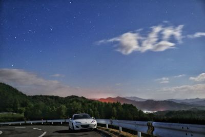 Cars on road against mountain range