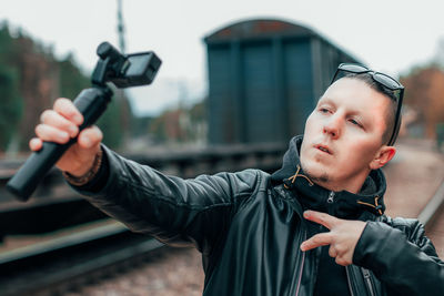 Portrait of young man photographing