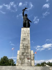 Low angle view of statue against cloudy sky