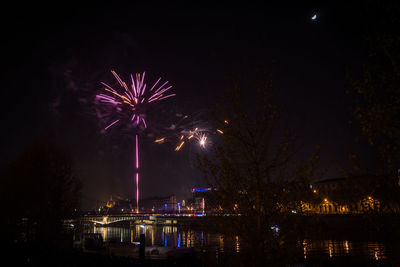 Low angle view of firework display at night