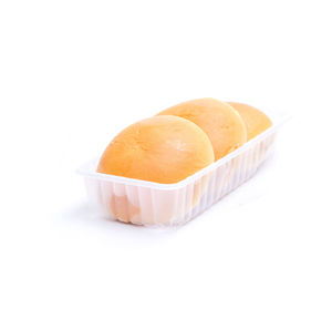 Close-up of buns in tray against white background