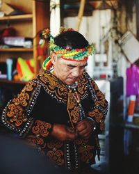 Rear view of man standing against multi colored indoors