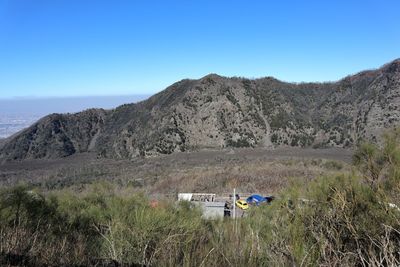 Scenic view of mountains against clear blue sky