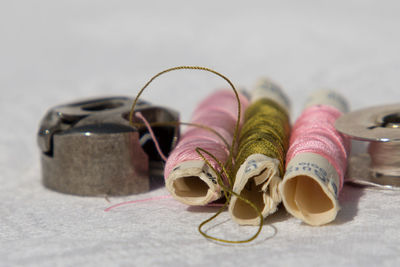 Close-up of thread spools and work tools on table