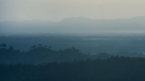 Scenic view of silhouette mountains against sky